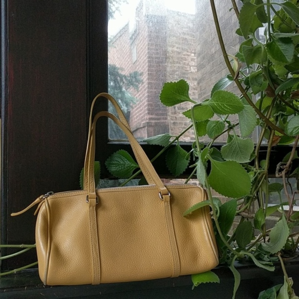 Dooney & Bourke yellow leather small barrel bag